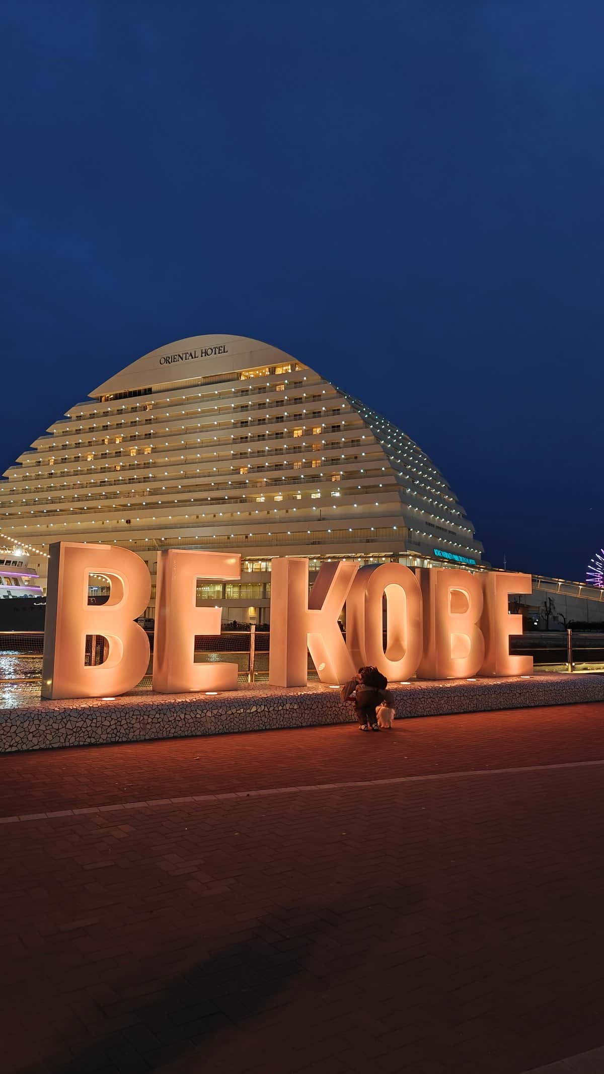 BE KOBE monument glowing at night with the