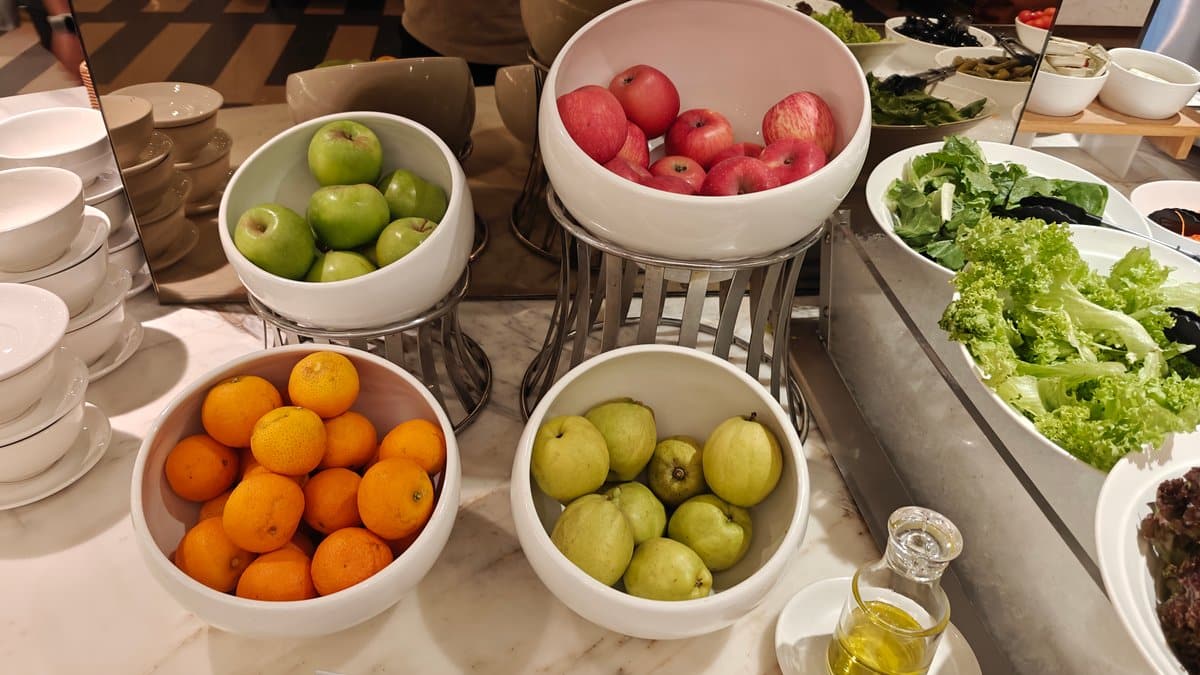 Bowls of fresh whole fruit: green apples, red