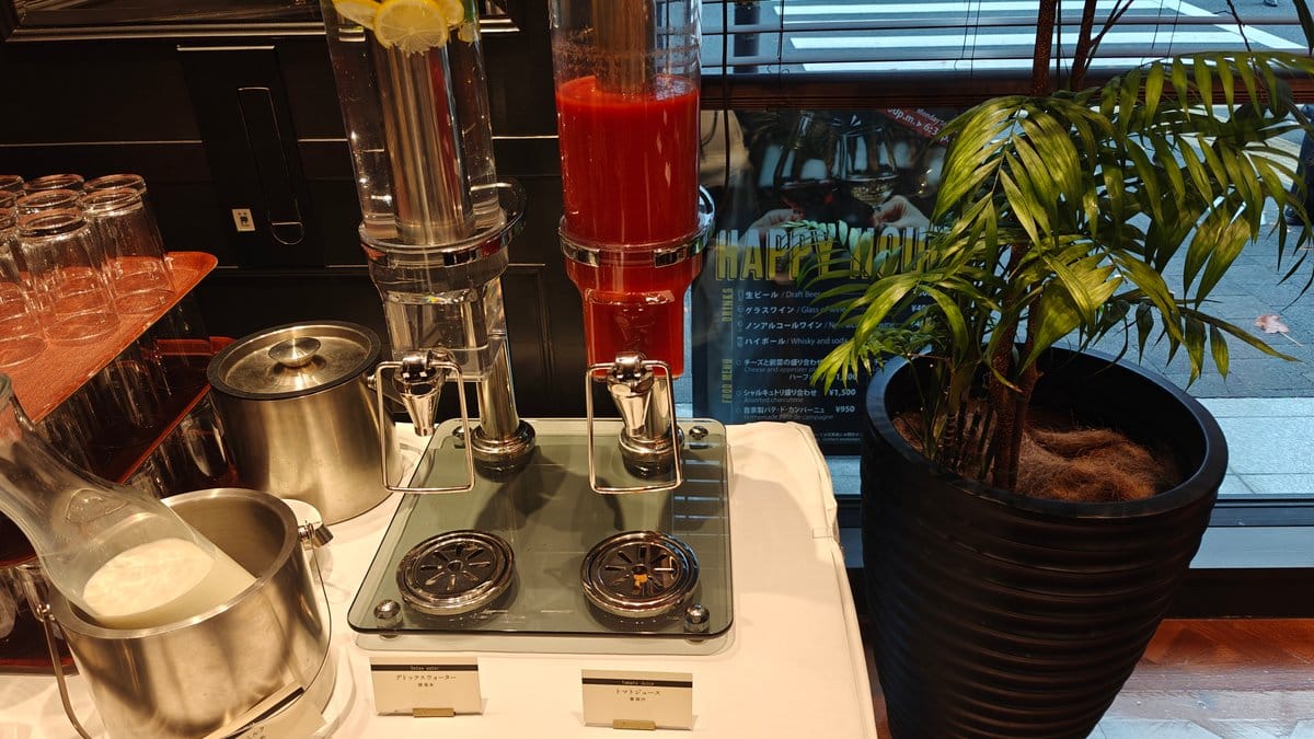Buffet drinks station with a red juice dispenser