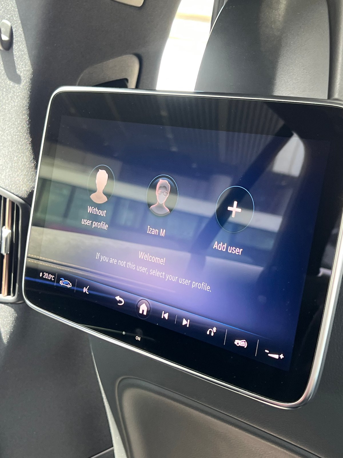 Car's rear touchscreen infotainment display showing a user-profile