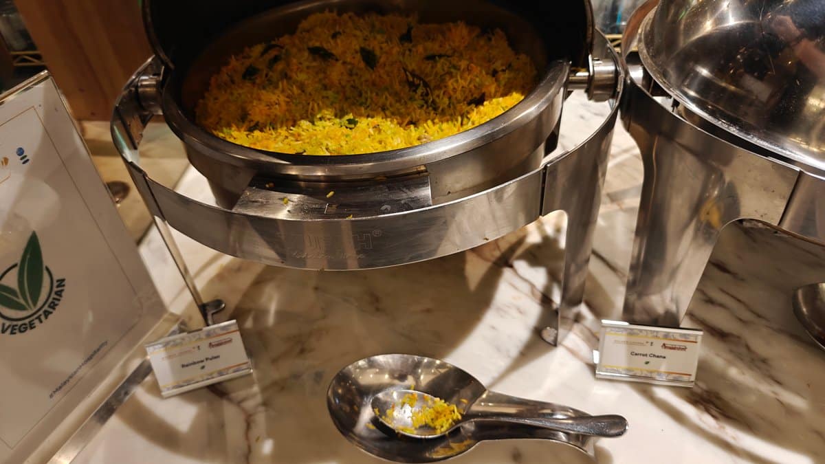 Chafing dish of Rainbow Pulao (turmeric rice) at