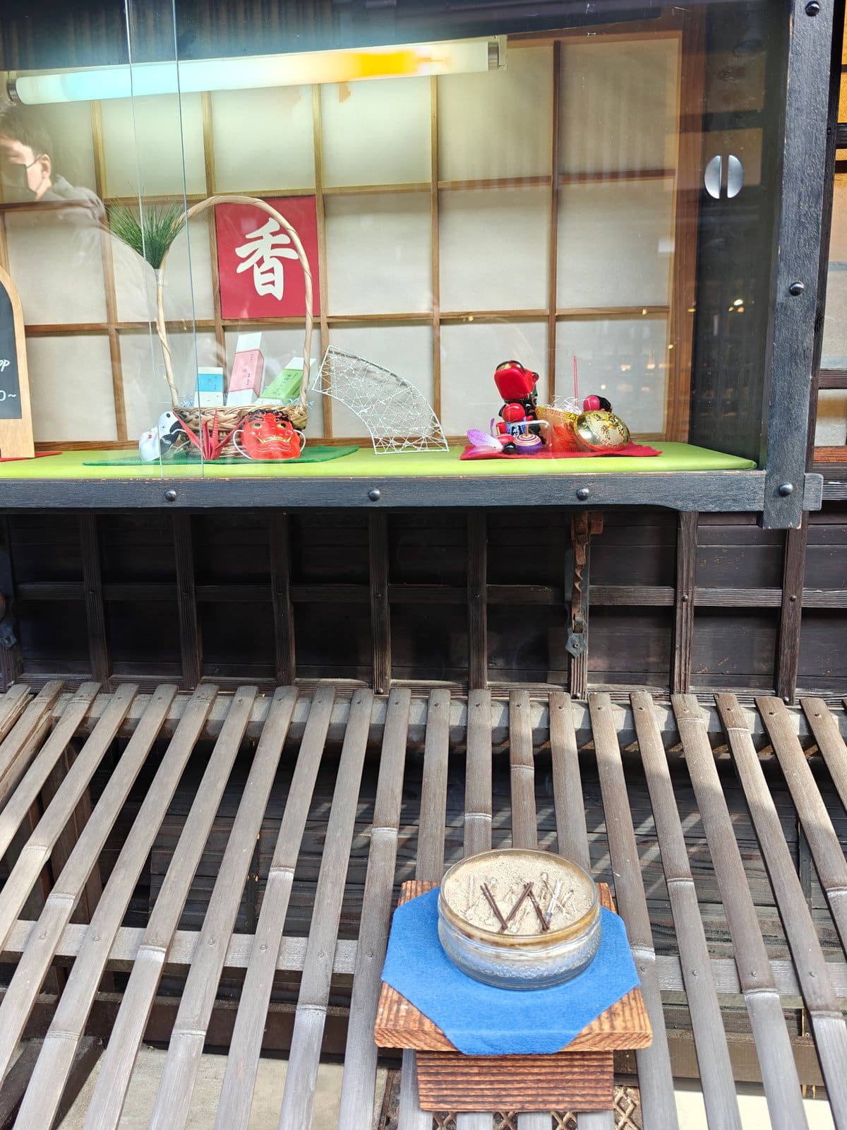 Close-up of the incense shop's window display: a