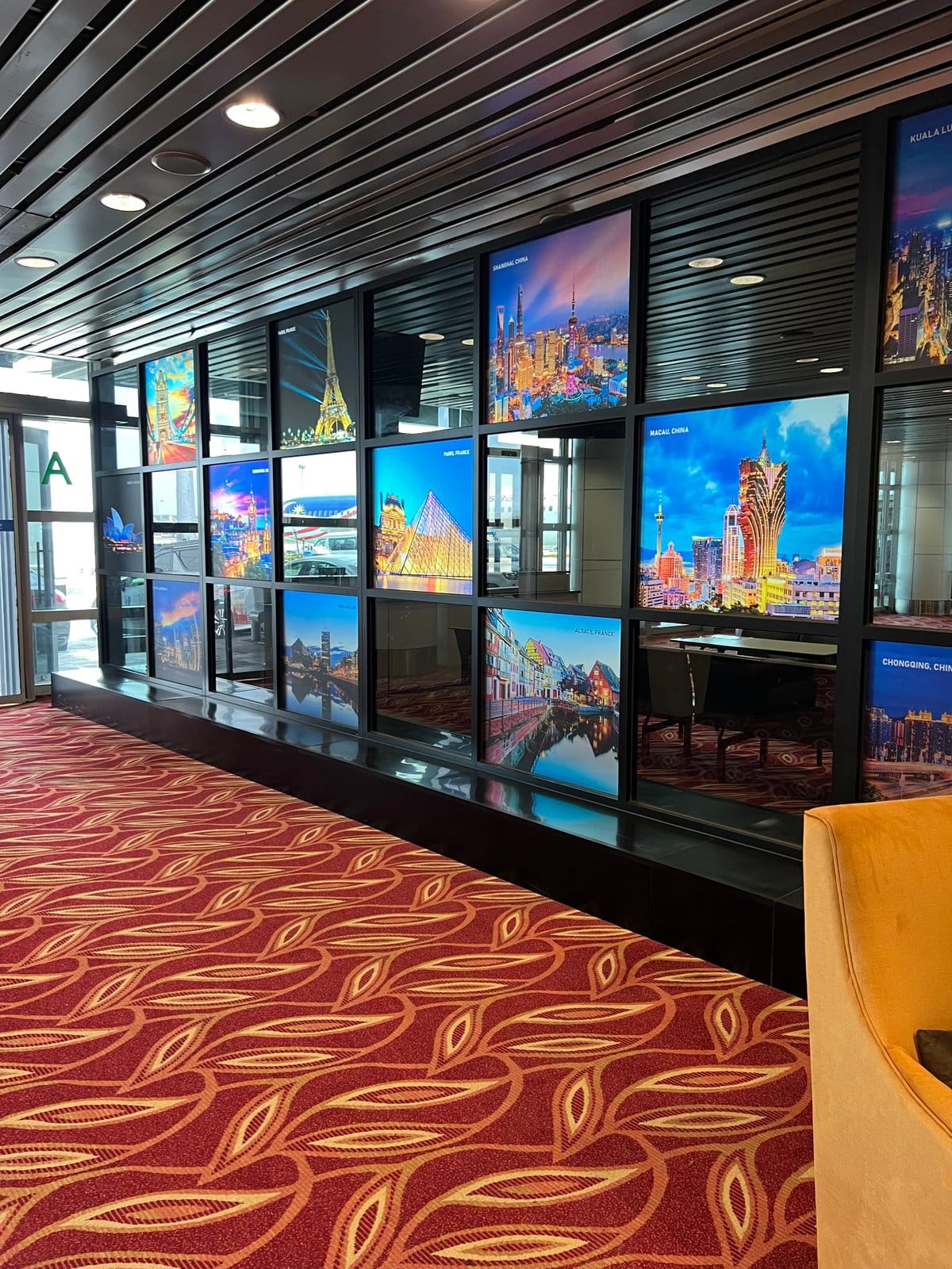 Corridor lined with digital advertising screens above a