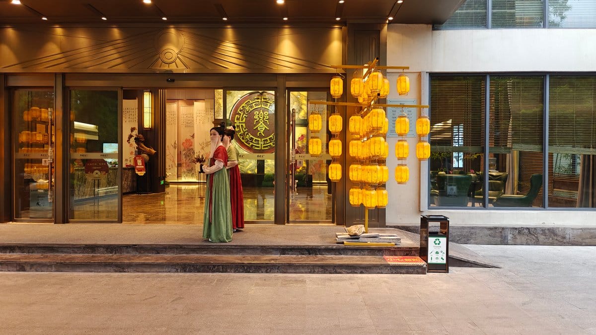 Entrance doorway with a hostess in Hanfu beside