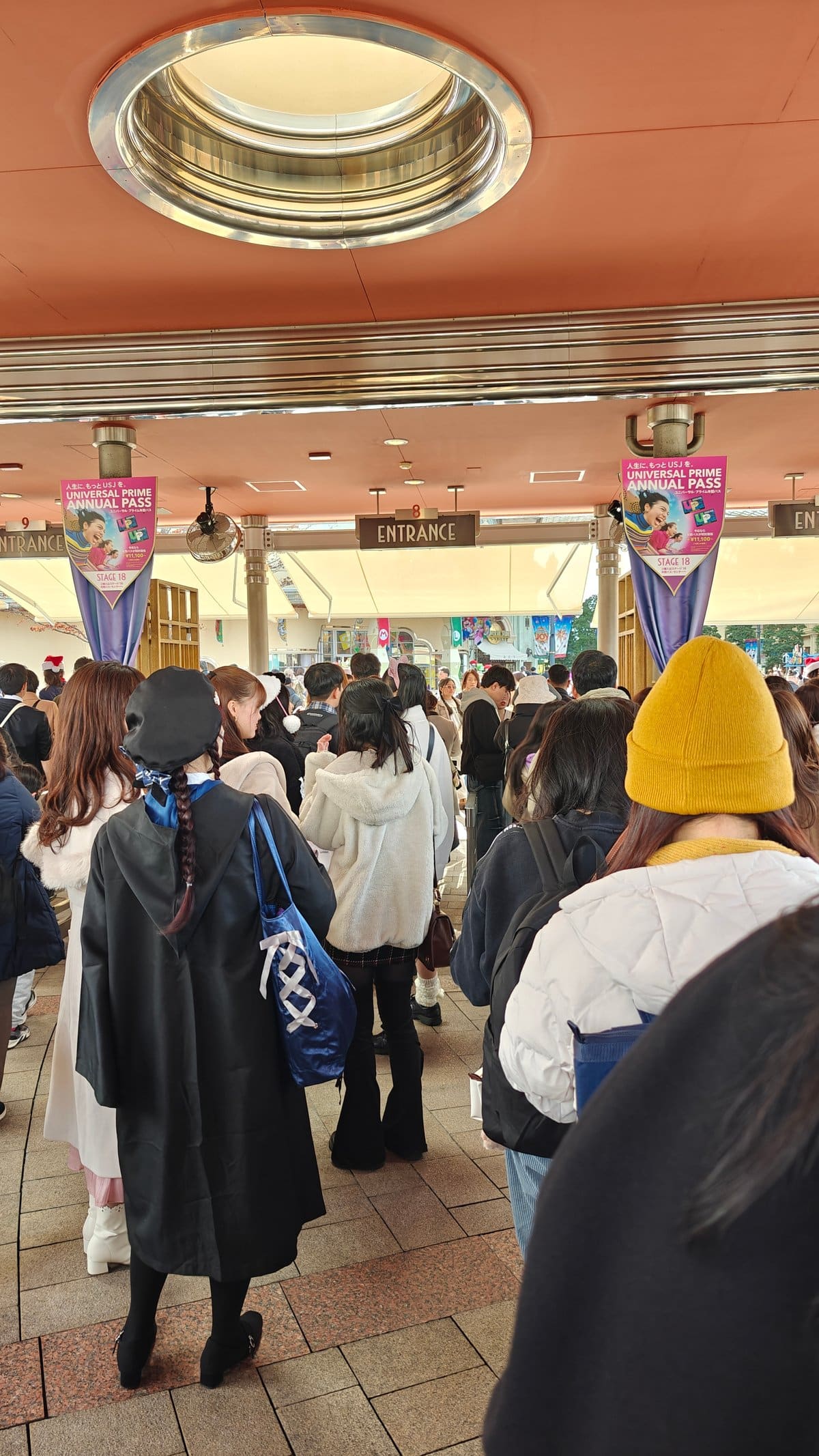 Entrance queue with visitors in Harry Potter robes