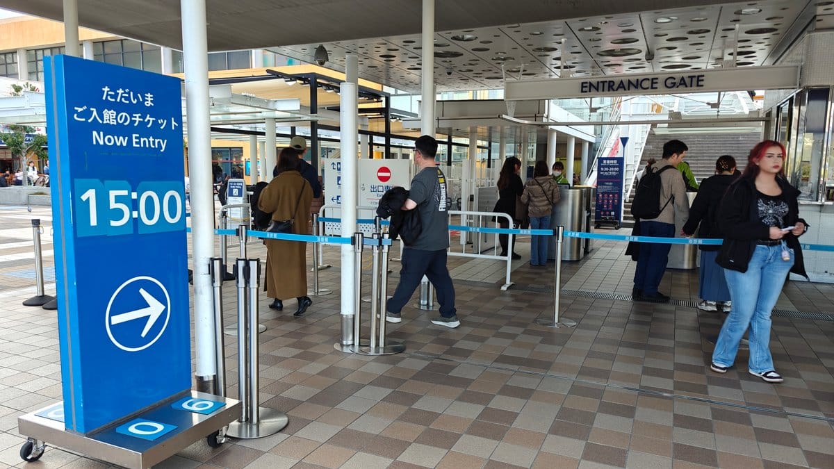 Entrance ticket area with signage, visitors waiting