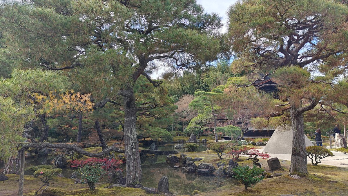 Garden trees with a temple building beyond