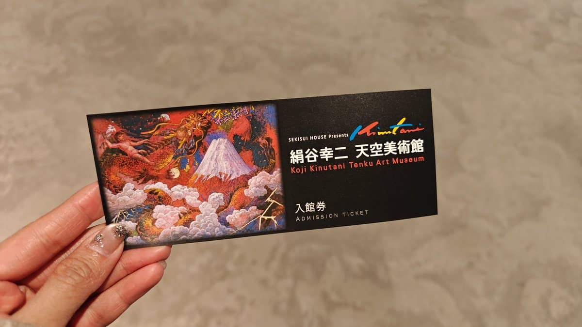 Holding the museum admission ticket showing the Koji