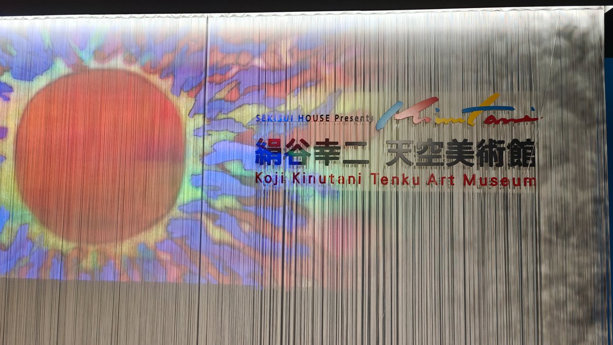 Illuminated entrance curtain with colourful sun artwork and