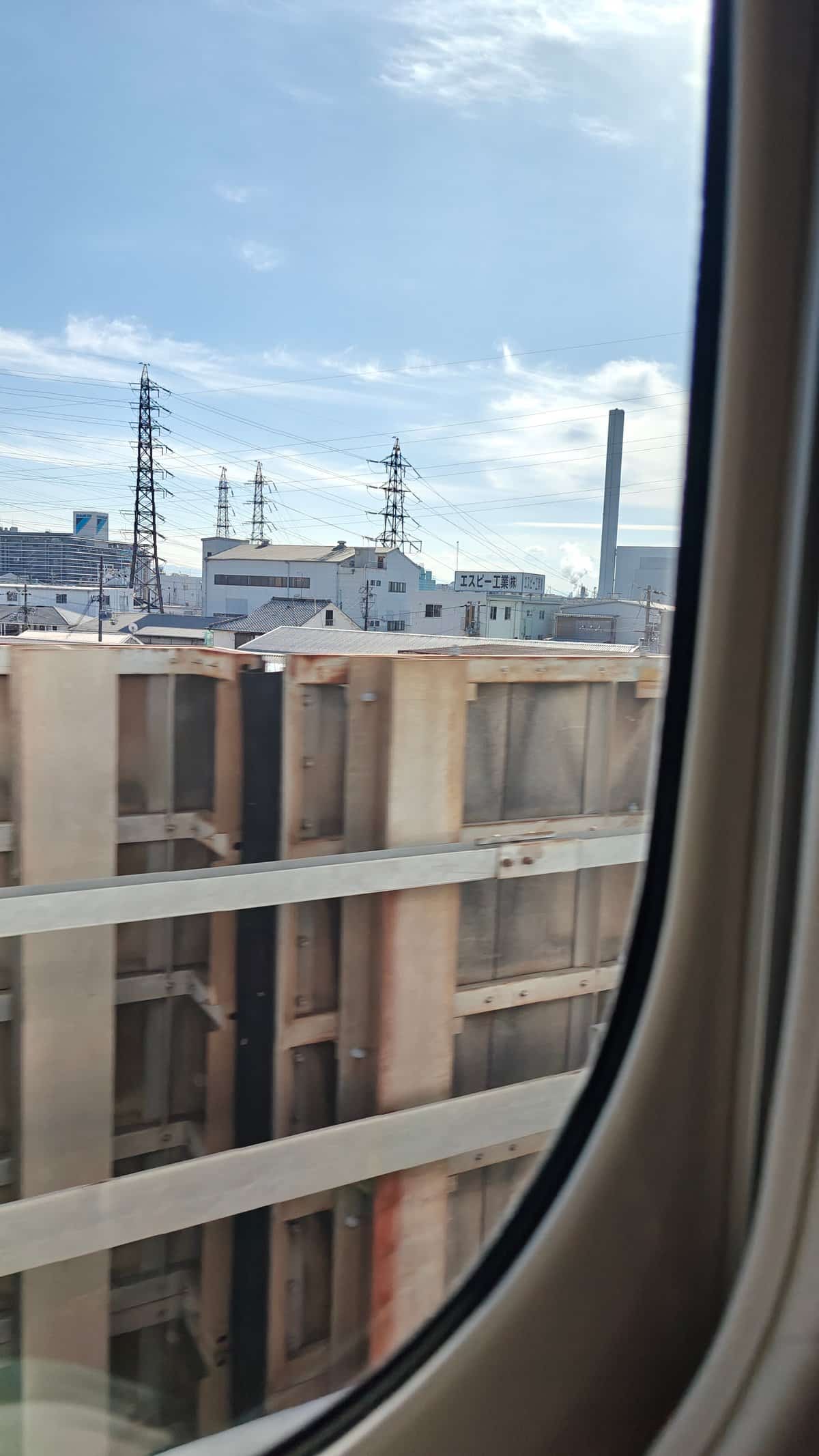 In-transit view out the train window of blue