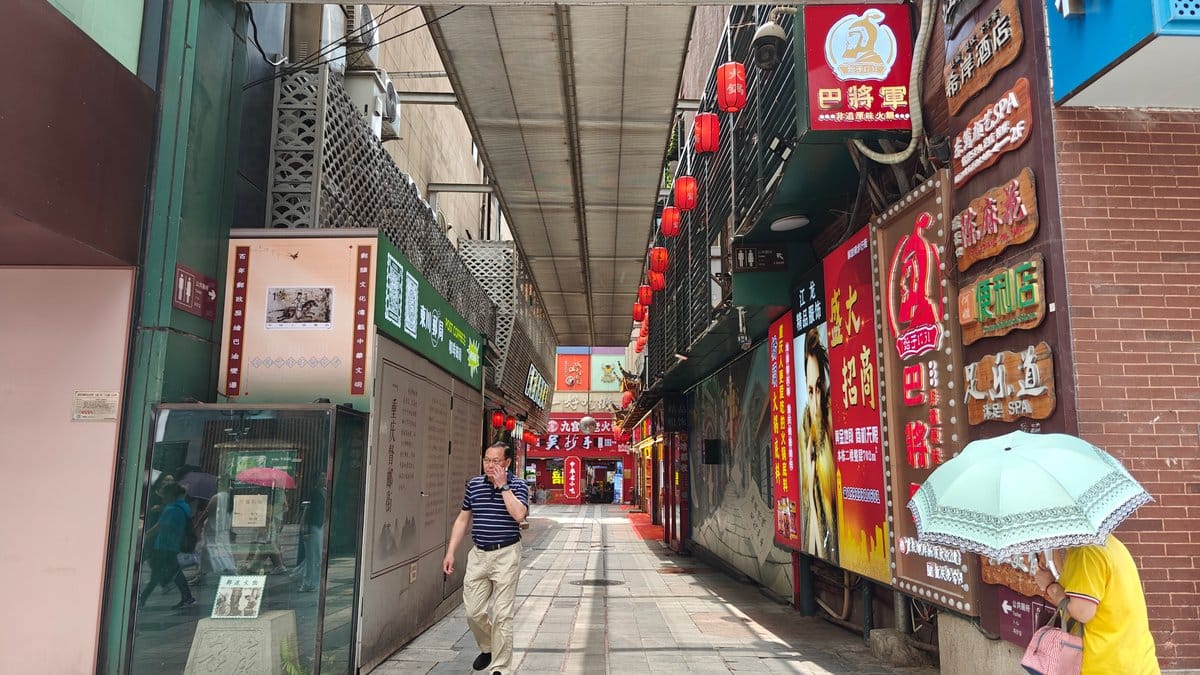 Looking down the covered lane — red lanterns,