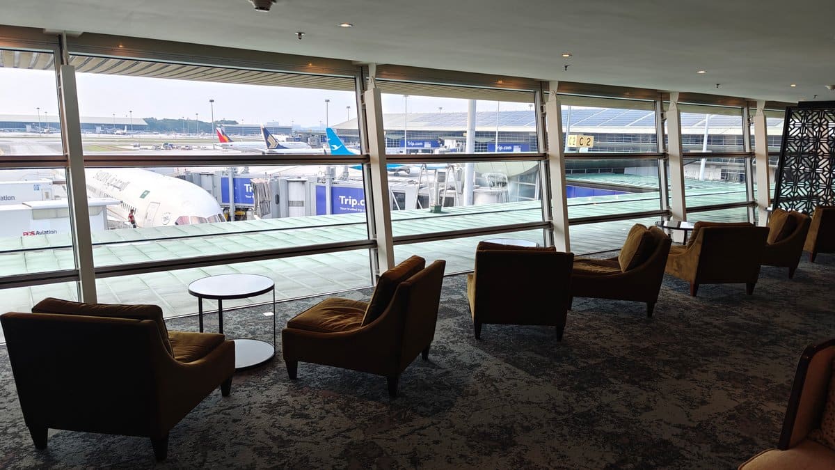 Lounge armchairs facing tarmac windows