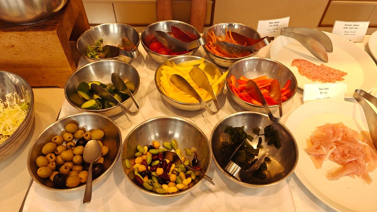 Marinated vegetables and olives in steel bowls with