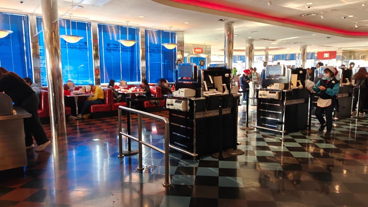 Mel's Drive-In interior with red booth seating, checkered