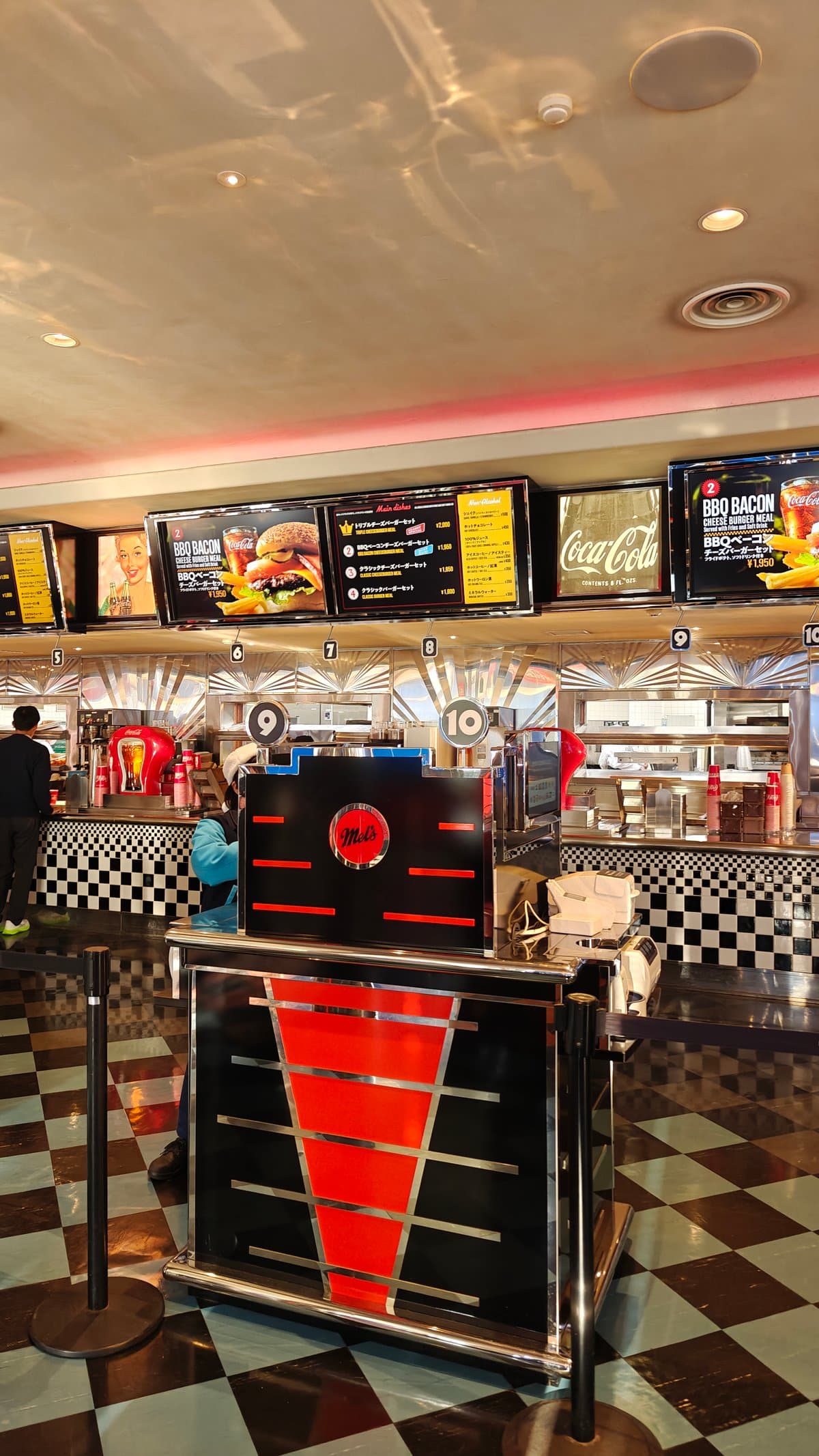 Mel's ordering counter with menu screens showing BBQ