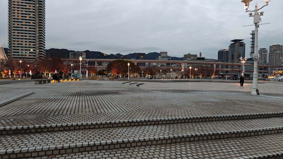 Meriken Park's wide granite plaza at dusk with