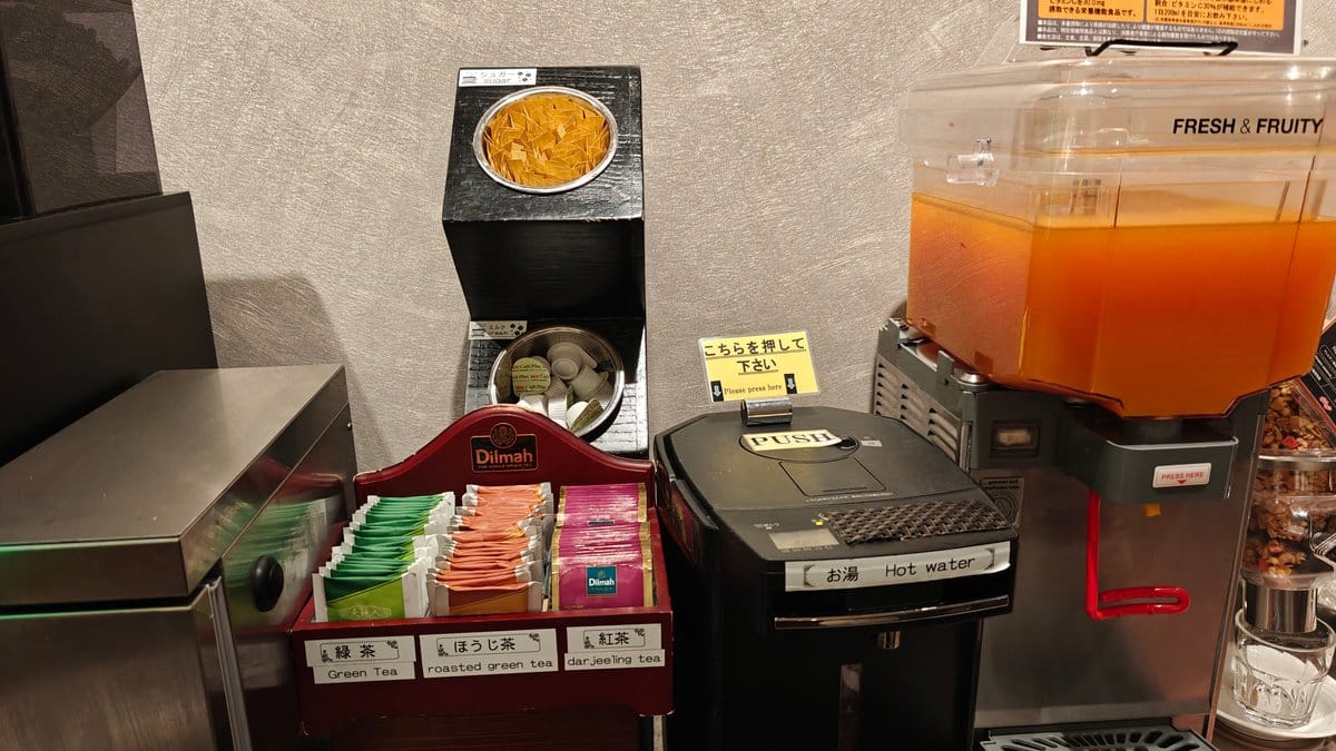 Orange juice dispenser with an assortment of teas
