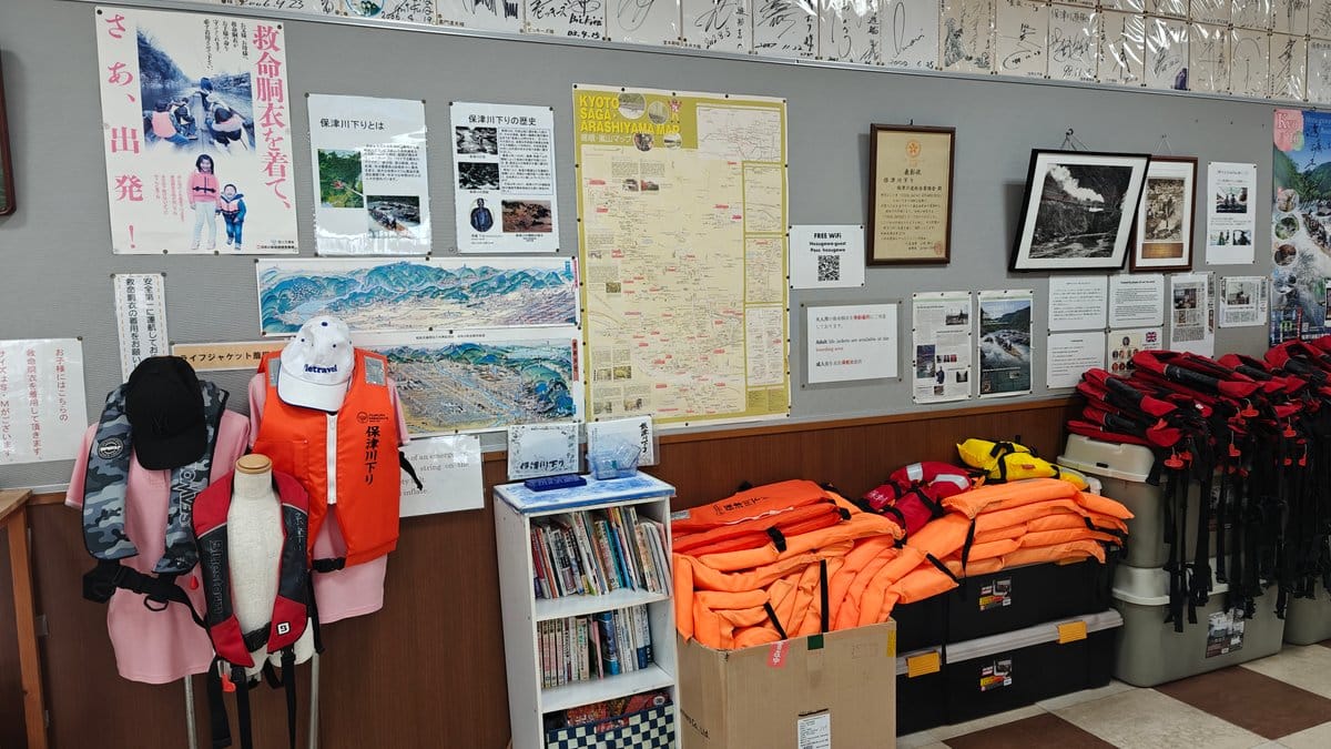 Orange life vests piled on display beside a