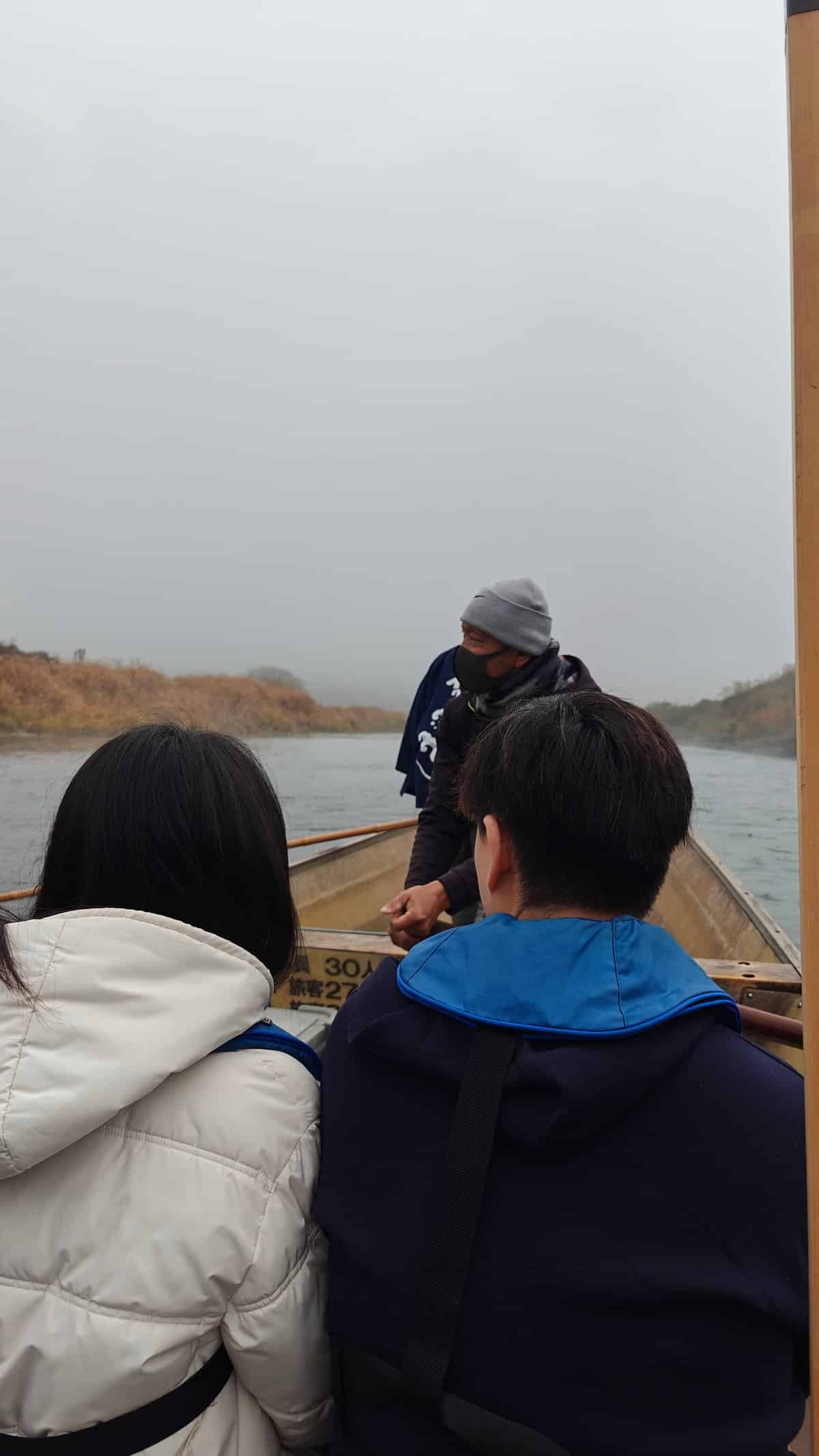 Passengers aboard misty river boat
