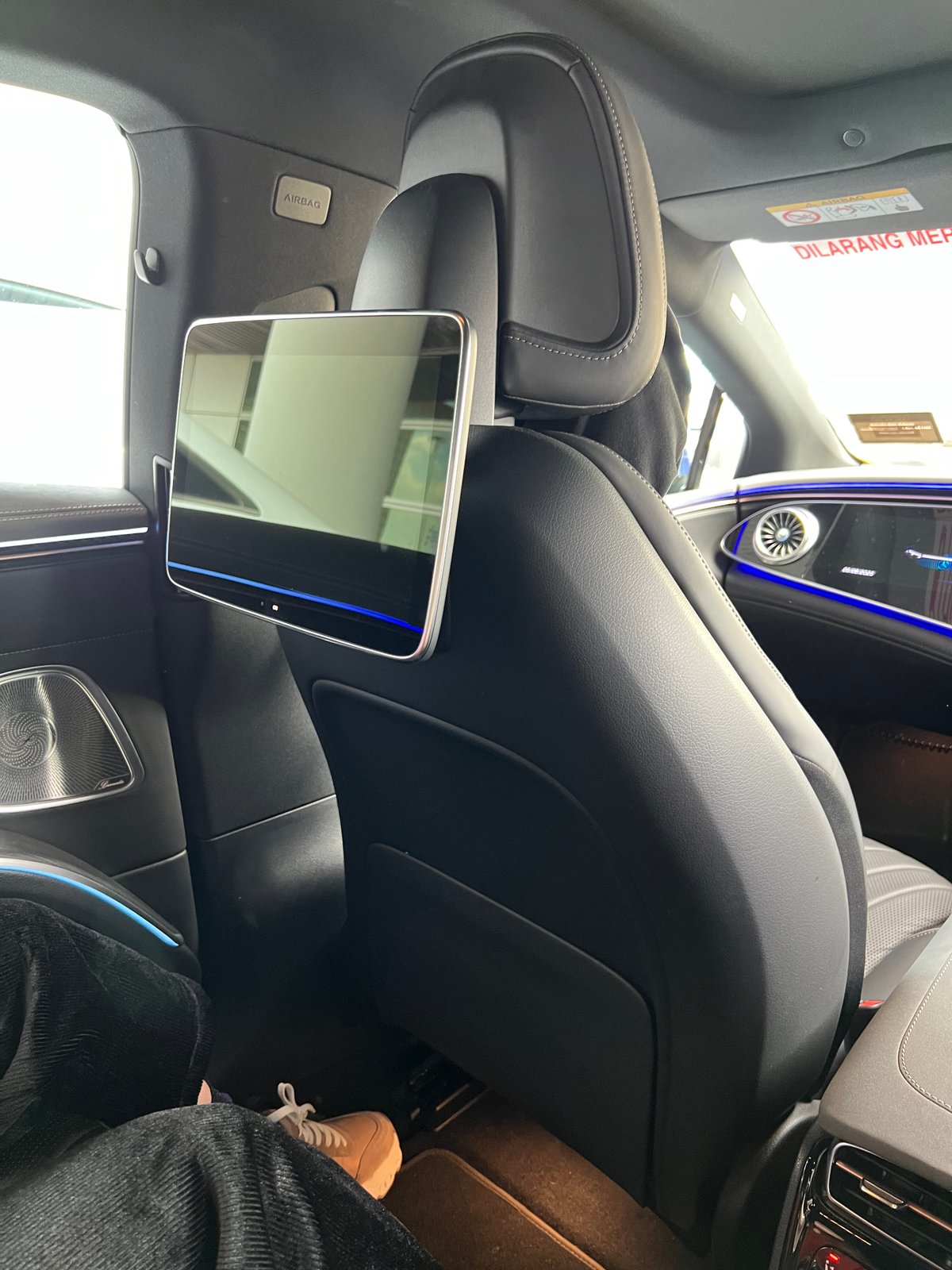 Rear-seat headrest-mounted entertainment touchscreen inside the private transfer