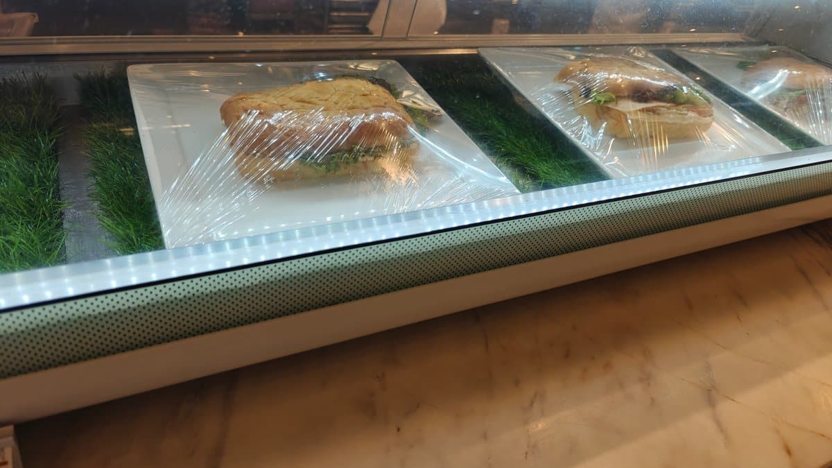 Refrigerated grab-and-go sandwich display case, sandwiches wrapped in