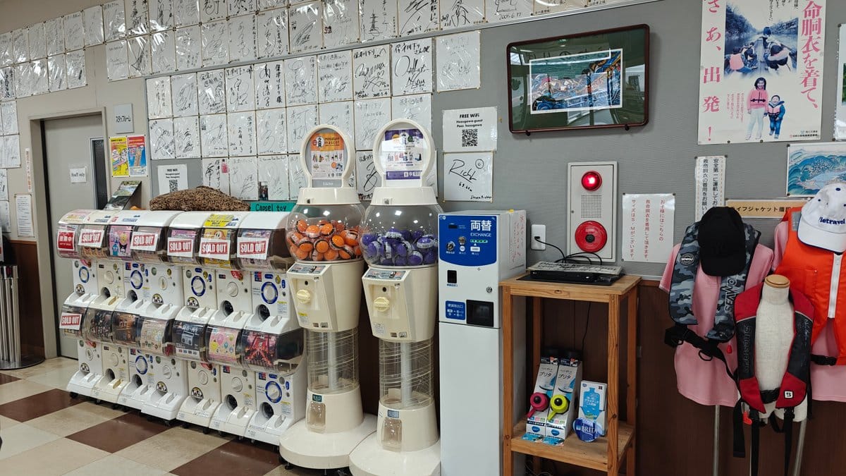 Row of capsule-toy (gachapon) machines and a coin-exchange