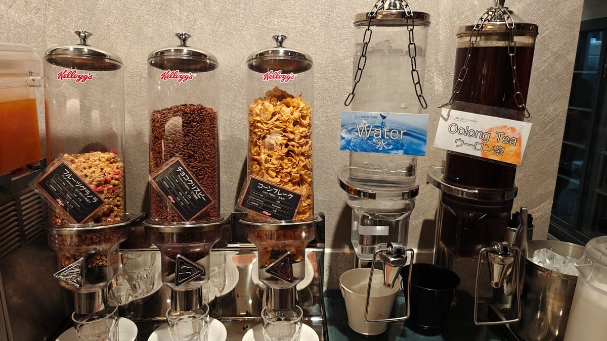 Row of glass dispensers with assorted cereals and