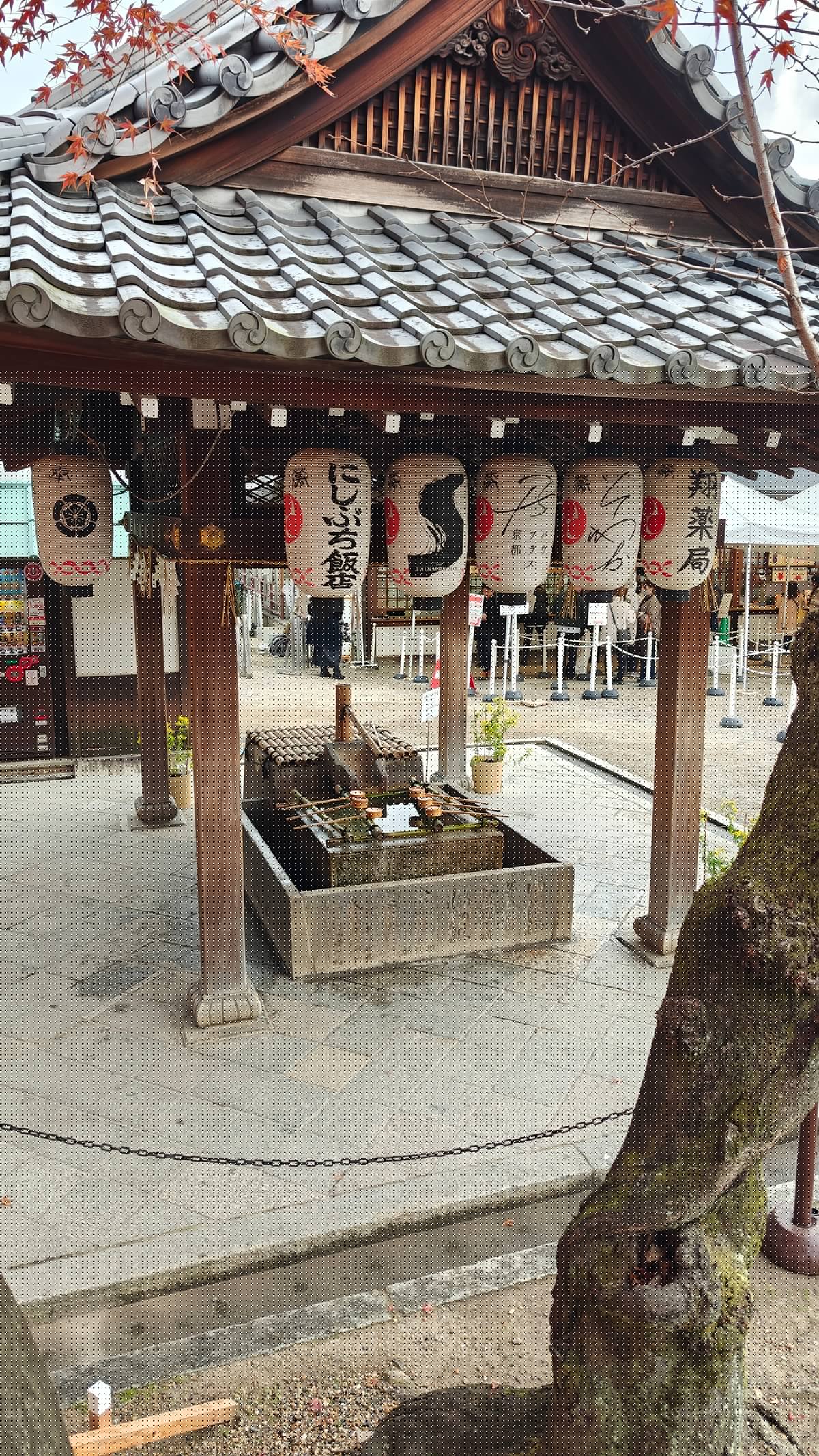 Shrine building hung with rows of lanterns beside