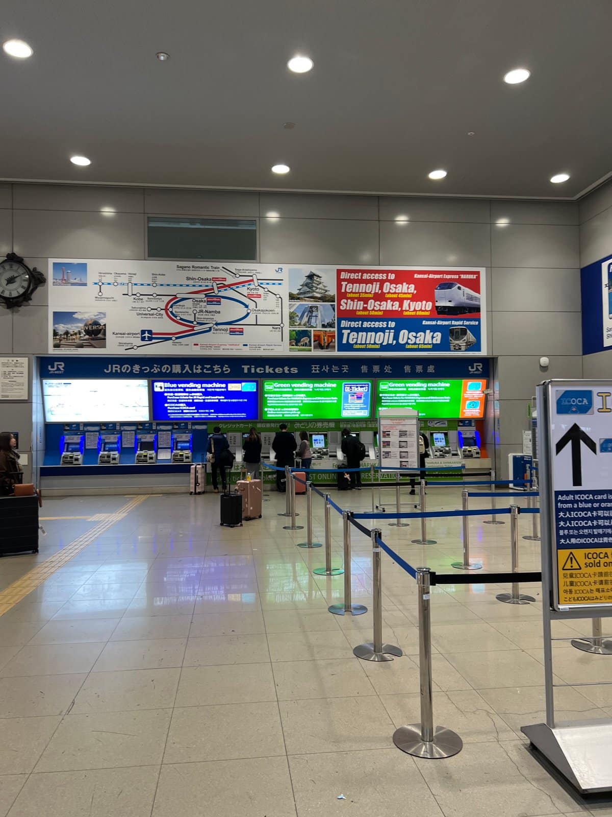 Station concourse with ticket machines and information screens