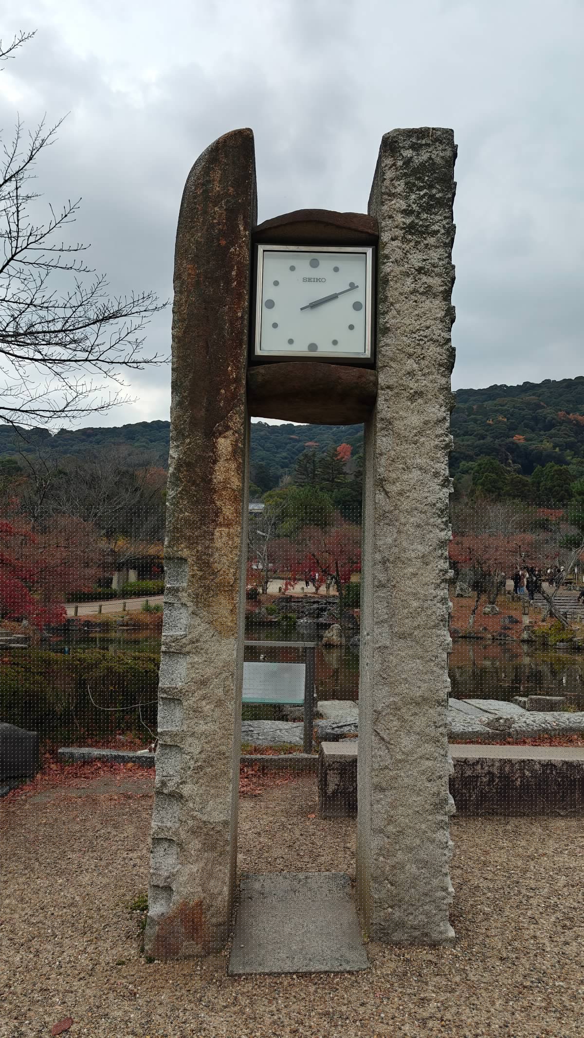 Stone-and-metal memorial clock monument