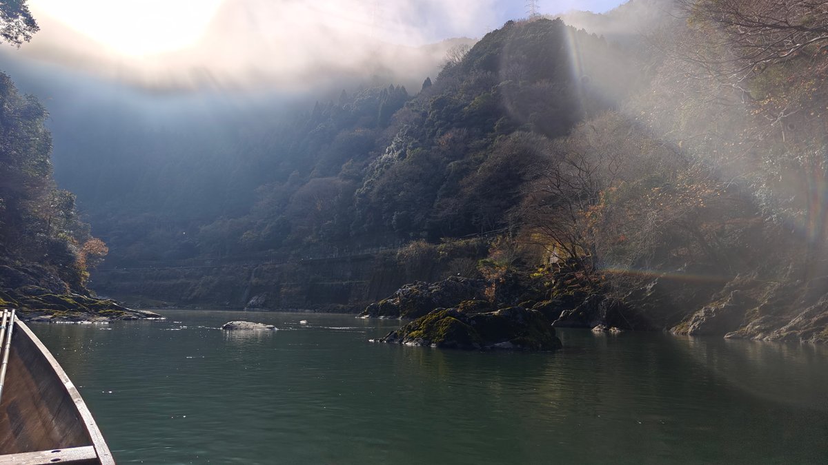 Sunlit mist over river and mountains