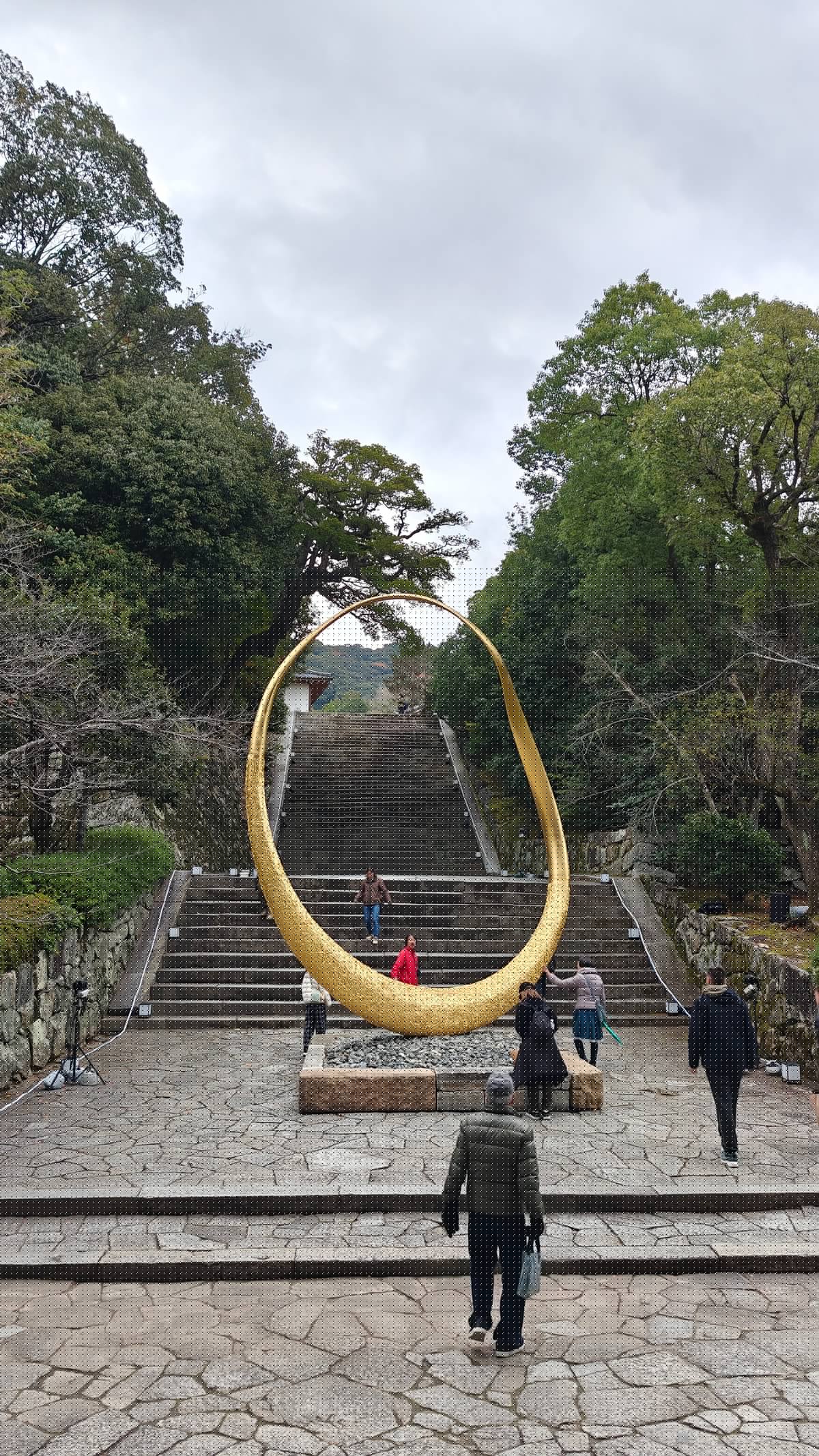 The golden ring sculpture before the grand stone
