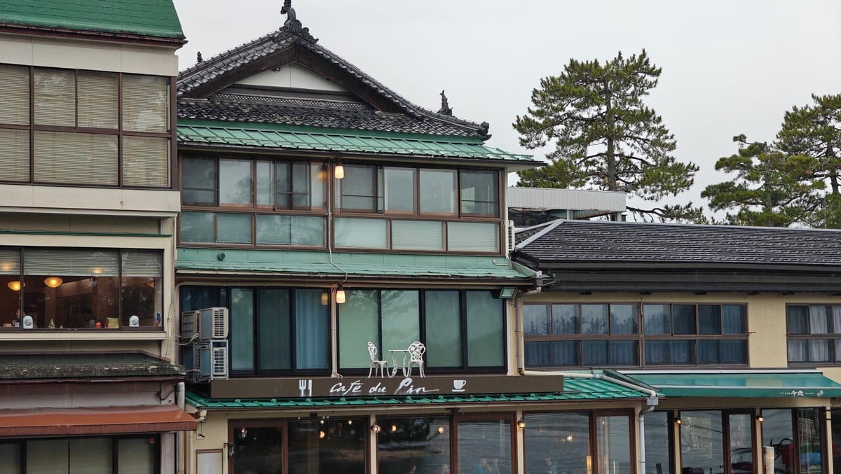 Traditional inn with a green tiled roof beside