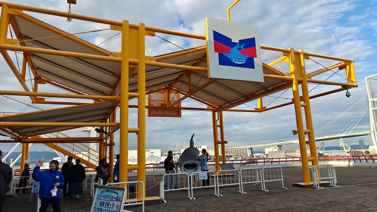 Waterfront promenade with bay cruise information and sculptures