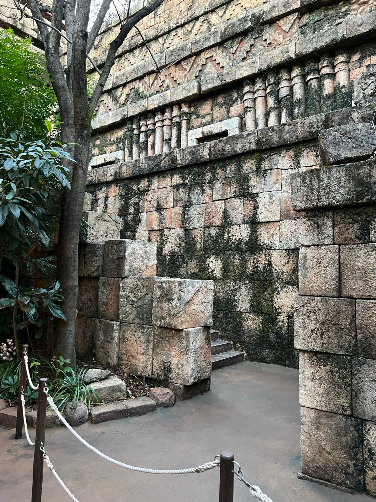 Weathered stone ruins wall with carved blocks and