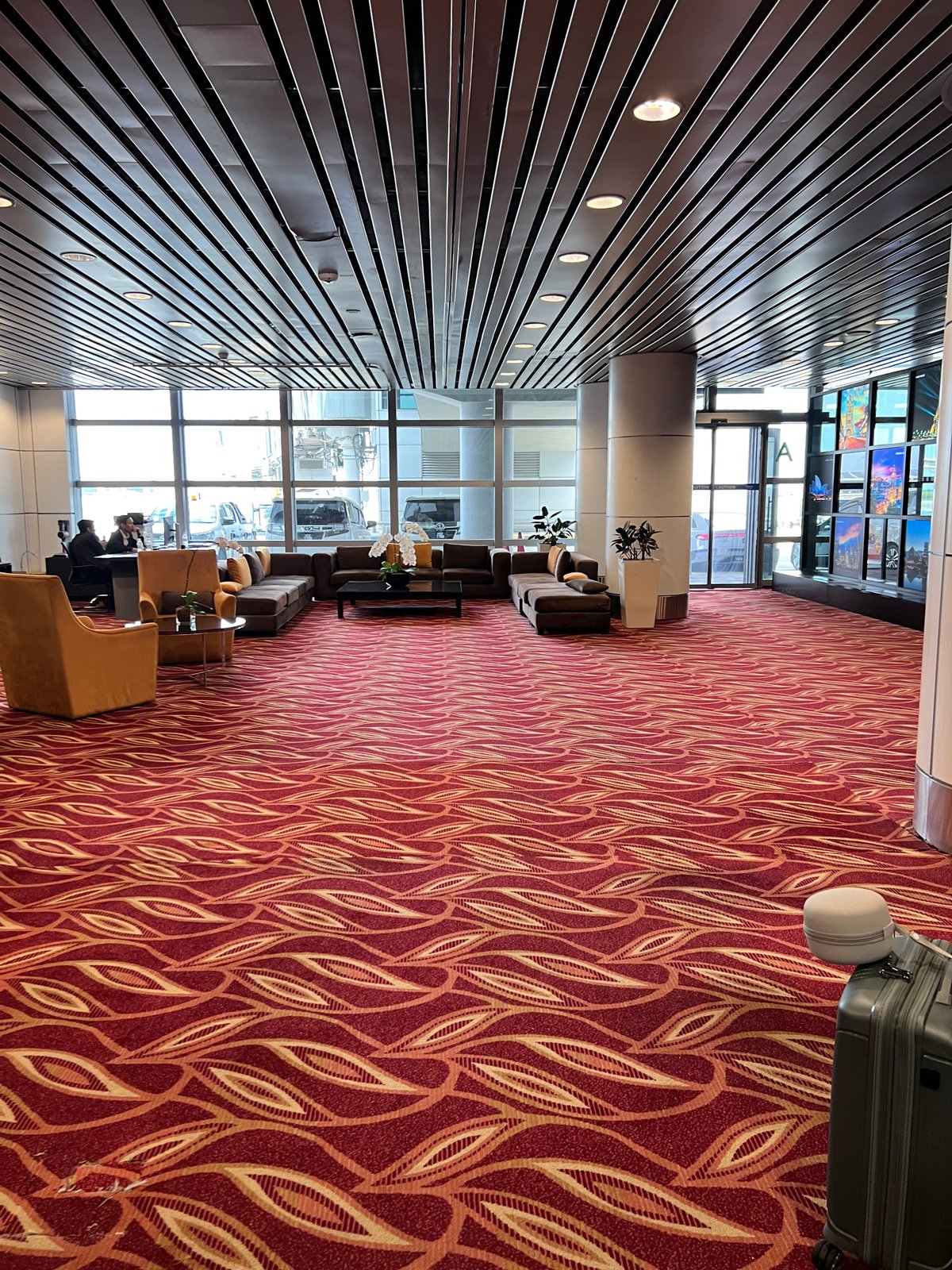 Wide interior view of a terminal corridor with