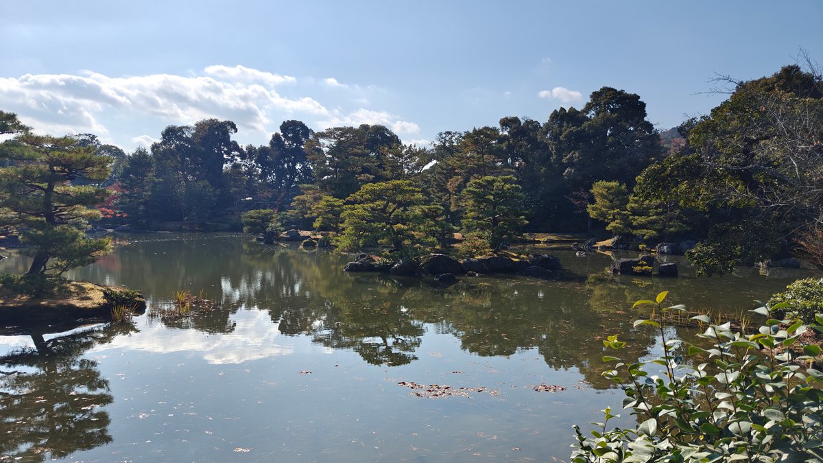 Wide pond view toward wooded hills