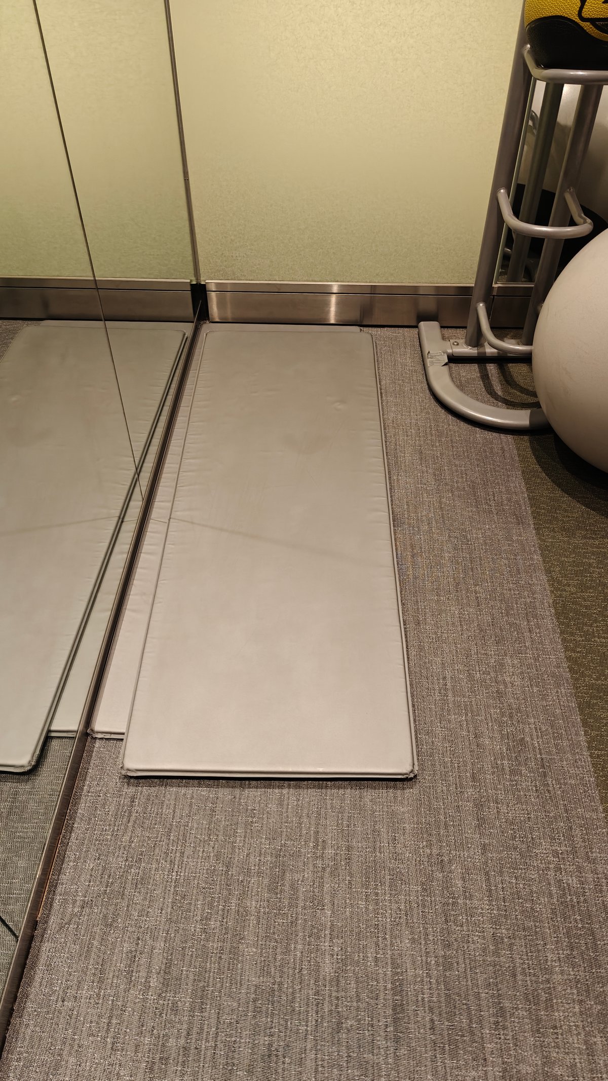 Yoga or floor exercise mat stored in equipment