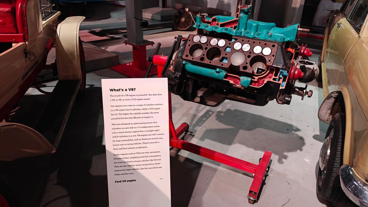 A blue engine block on display beside a