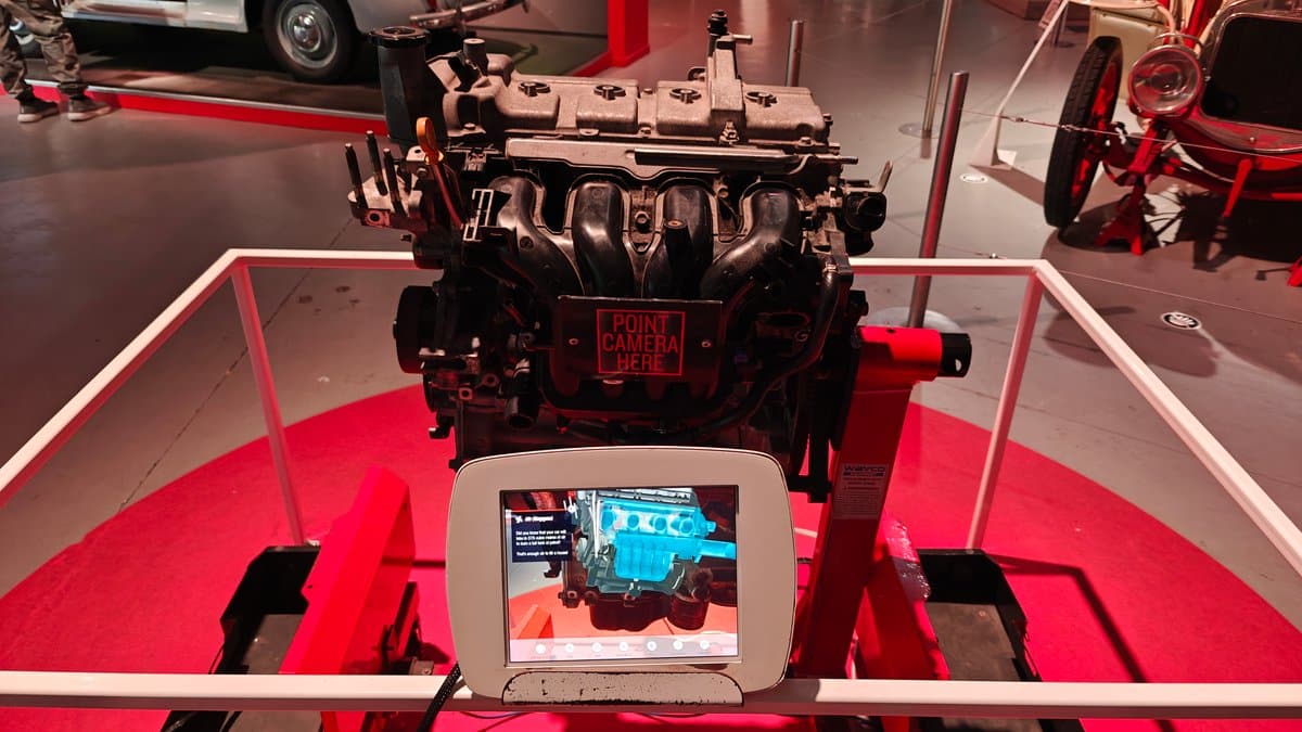 A car engine mounted on a red display