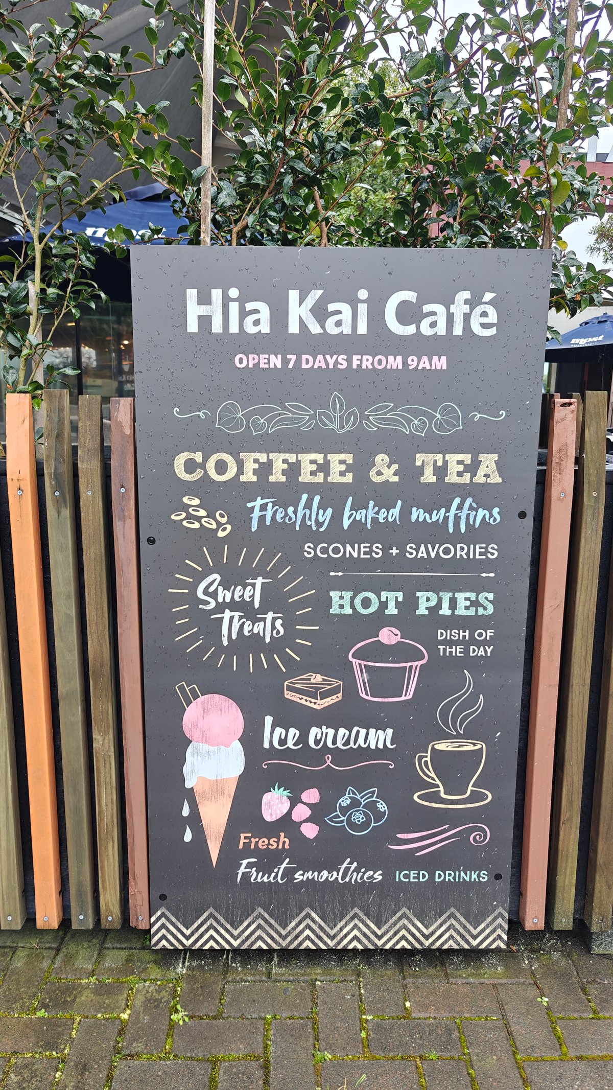 A chalkboard A-board reading Hia Kai Café, open