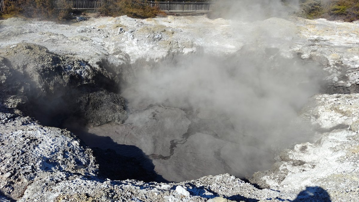 A crater with heavy white steam pouring out