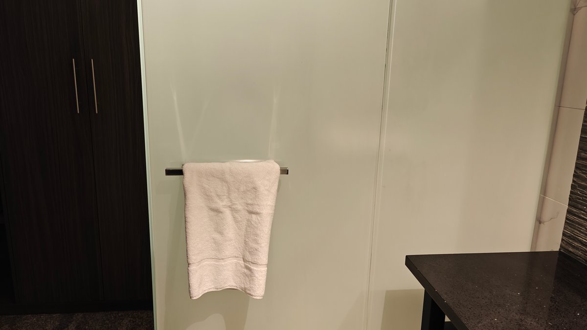 A folded towel on the rail beside the