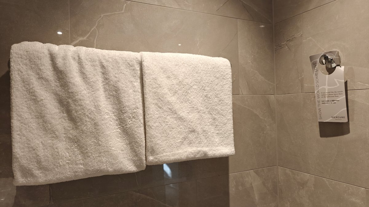 A folded towel over the rail on the