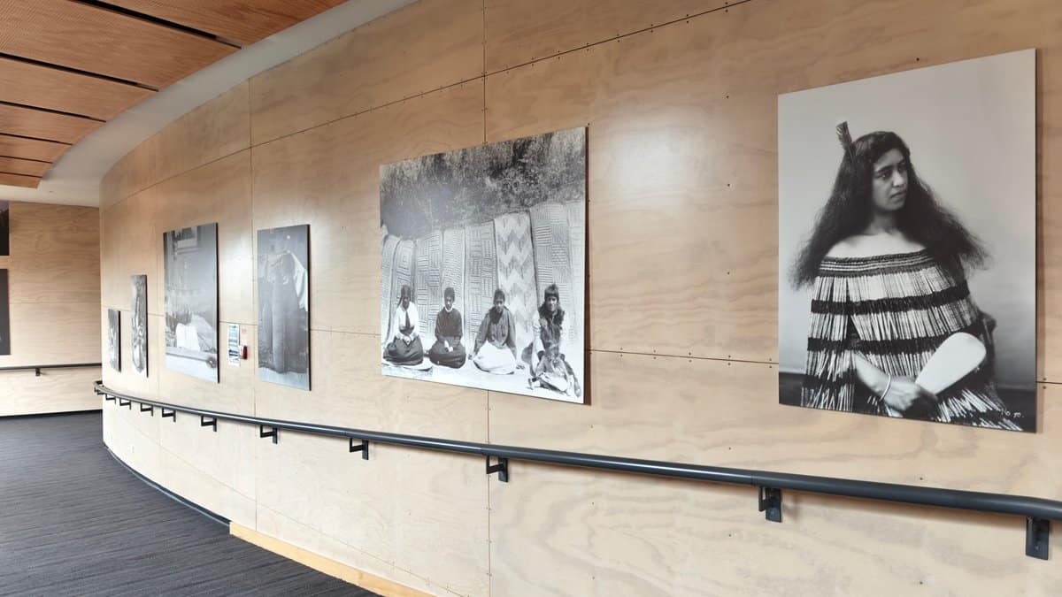 A gallery wall hung with historic black and