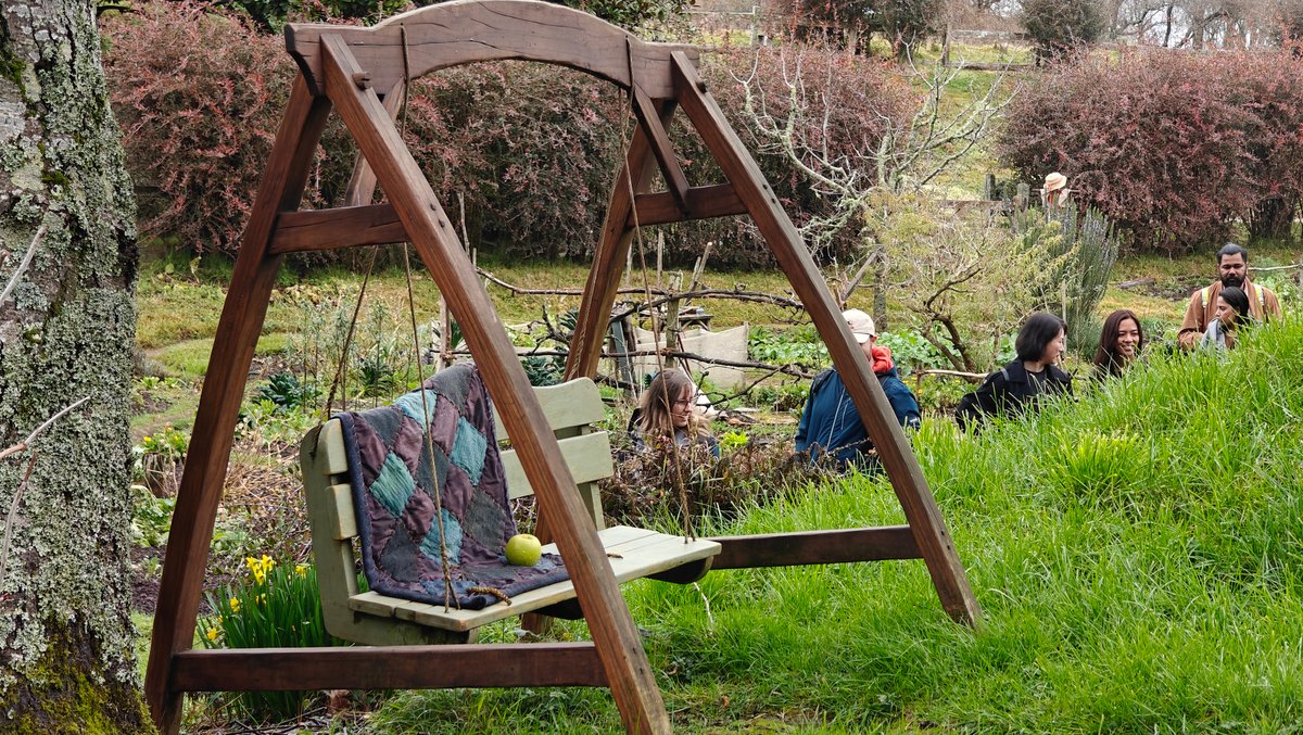 A garden swing seat on the grass with