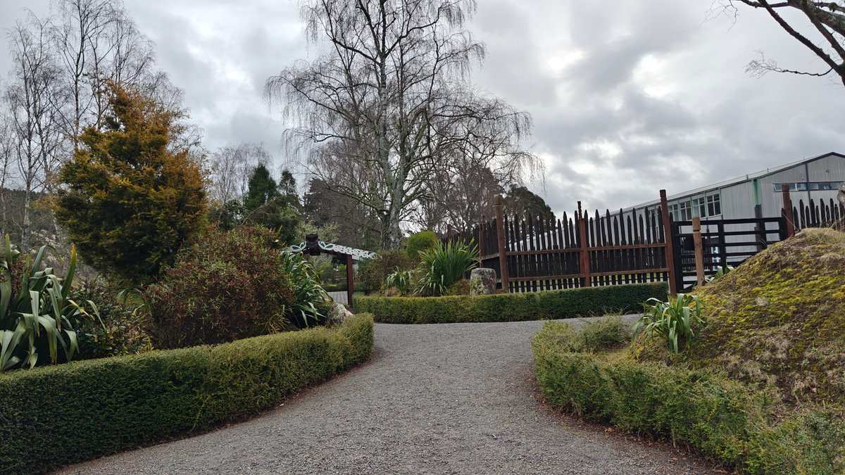 A gravel path curving through the grounds between
