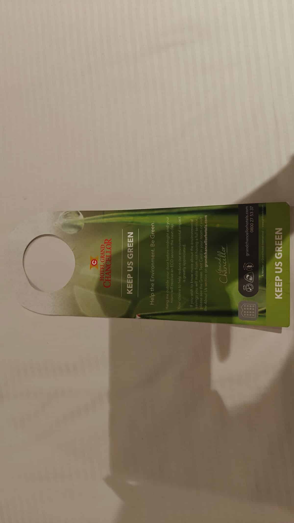 A green card hooked over the handle inviting