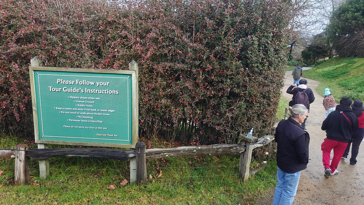 A green sign at the track head reading