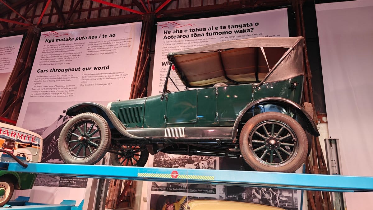 A green vintage open tourer with its interpretive